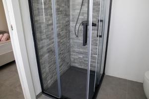 a shower with a glass door in a bathroom at VivimiHome - Monti House in Monti +17 photos
