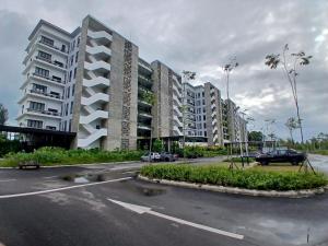a parking lot with tall buildings in a city at Ang Roxy Apartment A in Sematan