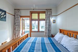 a bedroom with a bed and a window at Stylish Victorian Home Near Walk to Beach & Te Papa in Wellington