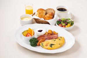 a plate of breakfast food with bread and other foods at Richmond Hotel Kagoshima Kinseicho in Kagoshima +45 photos