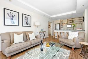 a living room with a couch and a table at Blouberg Heights 1608 by Host Agents in Bloubergstrand
