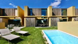 an exterior view of a house with a swimming pool at Villa Essence by CleverDetails central location, private pool in Quarteira