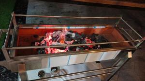a grill with a fire inside of it at Cozy Quiet escape from the City in Fatqā