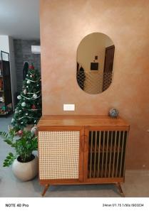 a christmas tree in a room with a mirror at Cozy Quiet escape from the City in Fatqā +18 photos
