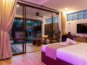 a bedroom with a bed and a living room at Capricho Villa El Nido in El Nido