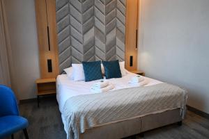 Postel nebo postele na pokoji v ubytování Hotel Centrum Malbork