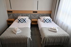 Postel nebo postele na pokoji v ubytování Hotel Centrum Malbork