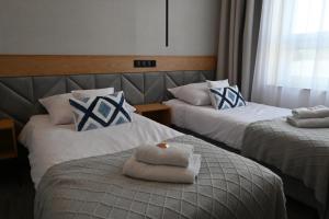 Postel nebo postele na pokoji v ubytování Hotel Centrum Malbork