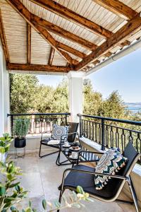 a patio with chairs and tables on a balcony at Chill Out Apartments Solea in Corfu Town