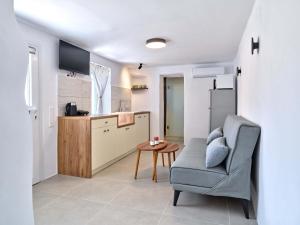 a living room with a couch and a table in a kitchen at Lefkes Blissful Home in Lefkes