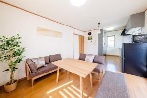 a living room with a table and a couch at Villa Lotus in Kamakura