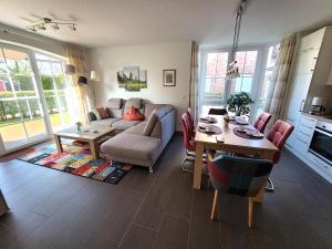 a living room with a couch and a table at Heubude in Greetsiel