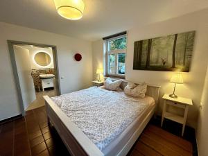 a bedroom with a bed and a window at Kuckucksnest - Ferienwohnung mit Traumblick im Schwarzwald in Bad Wildbad