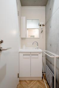 a white bathroom with a sink and a mirror at 原田屋Hotel 3F in Tokyo +37 photos
