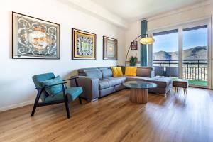 a living room with a couch and a table at Silk & Sunset - City and Lake View with parking in Como