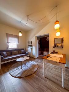 a living room with a couch and a table at Bebis House in Prosílion