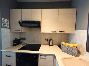 a kitchen with a counter with a basket of fruit at THE A-LINE SEAVIEW MALAMA APARTMENT with pool, tennis court & gym in Paralimni
