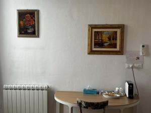 a room with a table and a picture on the wall at Mezzano B&B in Mezzano