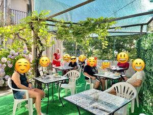 a group of people sitting at tables with smiles on their faces at Il borgo di Iaconti in Vietri sul Mare