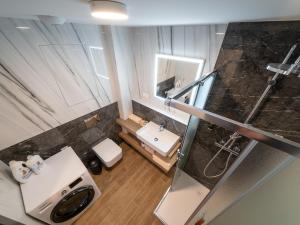 an overhead view of a bathroom with a sink and mirror at Eurovea Tower Apartments free Parking in Bratislava +43 photos