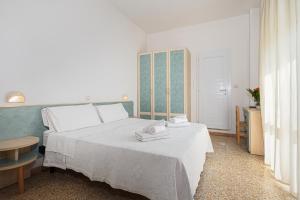 Postel nebo postele na pokoji v ubytování Hotel Luca