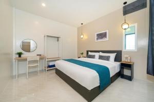 a bedroom with a large bed and a desk at 6BR Patong pool villa in Patong Beach +58 photos