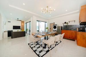 a kitchen and dining room with a table and chairs at 6BR Patong pool villa in Patong Beach