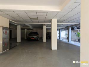 an empty parking garage with a car parked in it at Chic apart with parking near the airport in Douala