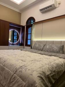 a bedroom with a large bed with a air conditioner at Guest House Omah Ningrat Surabaya in Surabaya +7 photos