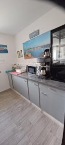 a kitchen with a counter top with a microwave at Letard Murielle in Ploudalmézeau