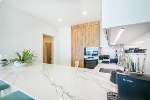 a kitchen with a marble counter top and a appliance at Sob O Mar III in Armação de Pêra