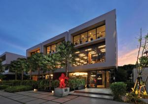 a building with a red ribbon in front of it at Stay Wellbeing & Lifestyle Resort in Rawai Beach