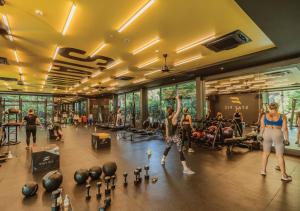 a group of people exercising in a gym at Stay Wellbeing & Lifestyle Resort in Rawai Beach