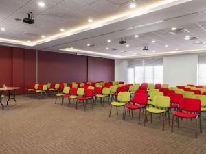 a conference room with red and yellow chairs and tables at ibis Ankara Airport Hotel in Ankara
