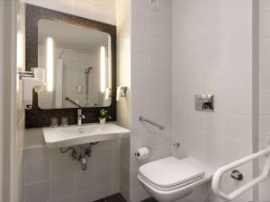 a bathroom with a sink and a toilet and a mirror at ibis Ankara Airport Hotel in Ankara