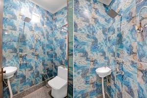 a bathroom with a toilet and a sink at Hotel O A.j Guest House in New Delhi