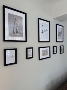 a group of framed pictures on a wall at Le Moulin , Cinema , Terrain Tennis BY PRIMO C0NCIERGERIE in Cuisery