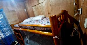 a bedroom with a bunk bed in a room at J Travel Trail Homestay in Hubangon, Camiguin in Mahinog