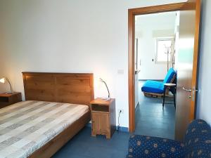 a bedroom with a bed and a chair in it at Afr0dite'home Historic Center Otranto Seafront in Otranto