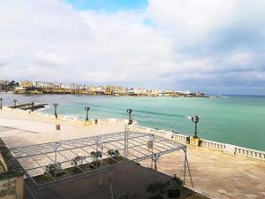a view of a beach with buildings and the ocean at Afr0dite'home Historic Center Otranto Seafront in Otranto