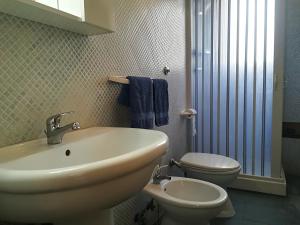 a bathroom with a sink and a toilet at Afr0dite'home Historic Center Otranto Seafront in Otranto +20 photos