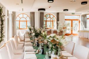 a long table with white chairs and flowers on it at Zamek Księża Góra in Karpacz +45 photos