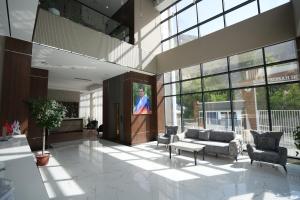 a lobby with a couch and chairs in a building at CONTINENTAL DARVOZ Hotel in Dashtak
