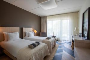 Rúm í herbergi á Hedon Spa & Hotel