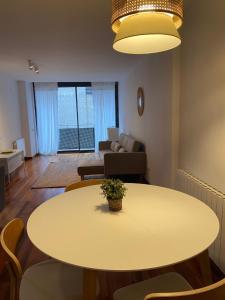 a living room with a table and a couch at Mai&Maud Fira Apartment in Hospitalet de Llobregat