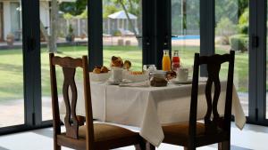 a table with a plate of food on it at Somer House Guest Suites in Somerset West