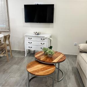 a living room with a table and a tv at Casa la florida in Puebla de Sanabria