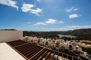 a view of a city from the roof of a building at Modern penthouse with two terraces, jacuzzi and sea, lake and mountain views, in Almazara Hills in Istán