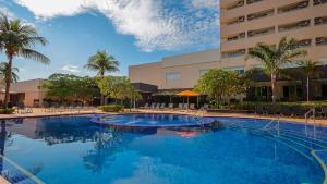 a large swimming pool in front of a hotel at Hot Beach Celebration in Olímpia