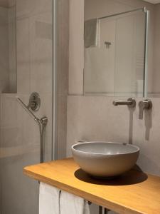 a bathroom with a bowl sink on a counter at Il GrecAle - Camere e Appartamenti in La Morra